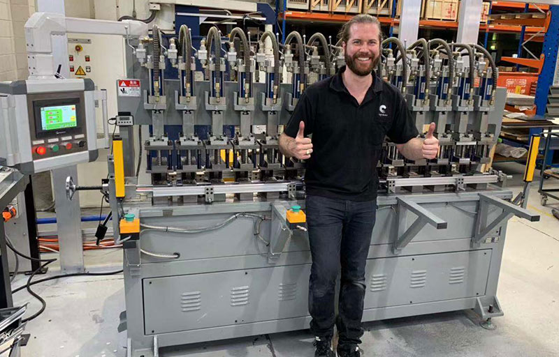 Australian customer giving thumbs up in front of ladder machine