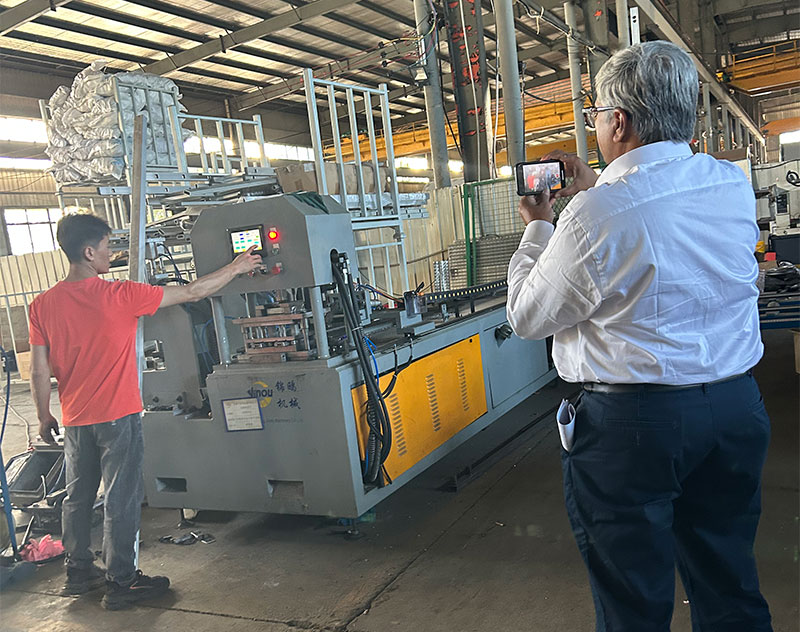 Indian customer is filming the ladder automatic punching machine working